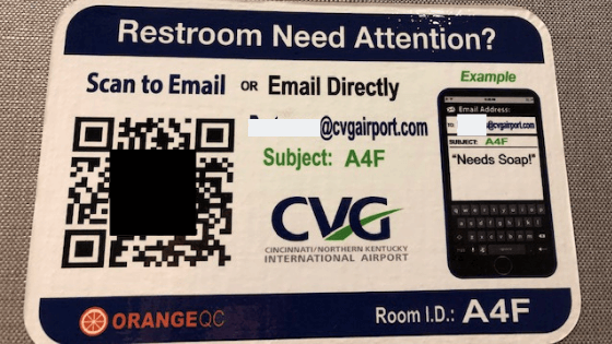   CVG posts placards showing how travelers can leave feedback on the state of the restrooms via OrangeQC. (Photo courtesy of CVG.)  