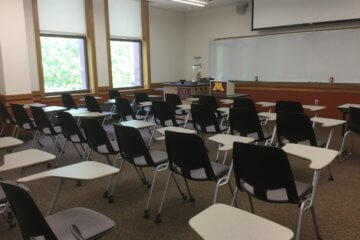 Neat rows of chairs in a clean classroom.