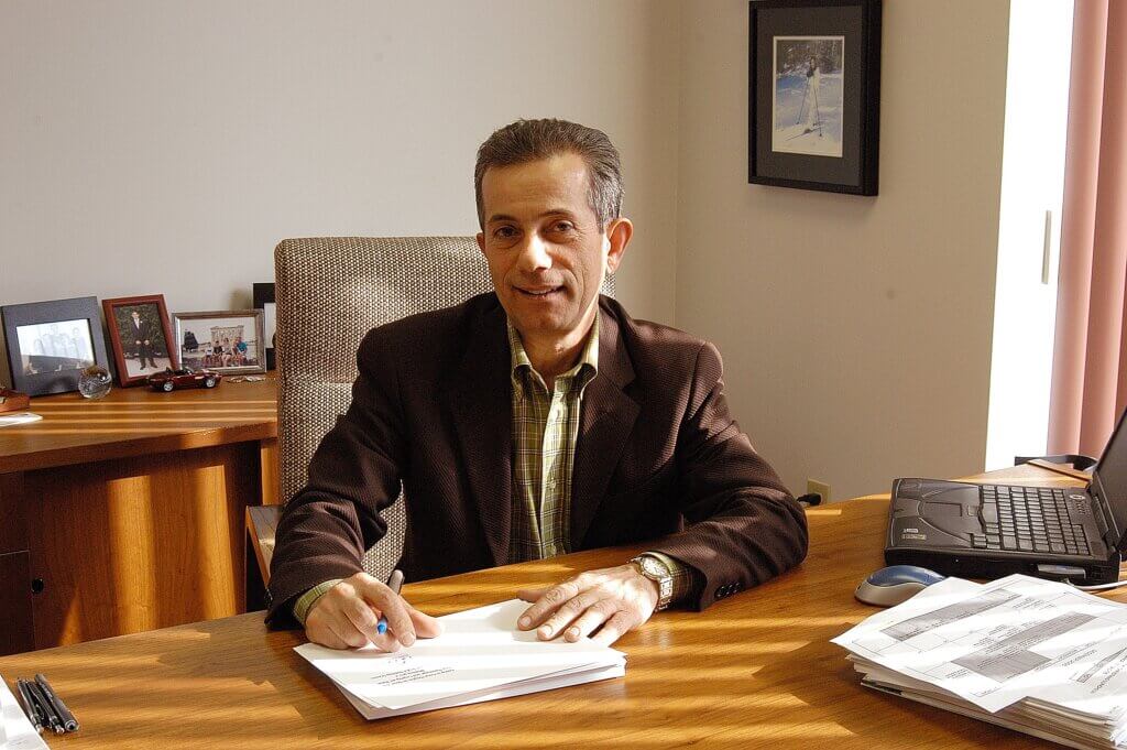 Chris Boutsalis sits at his desk in a photo from the early 2000s.