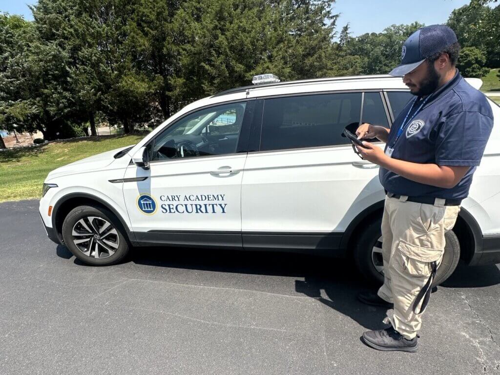 Cary Academy security staff using OrangeQC on a tablet in the parking lot.