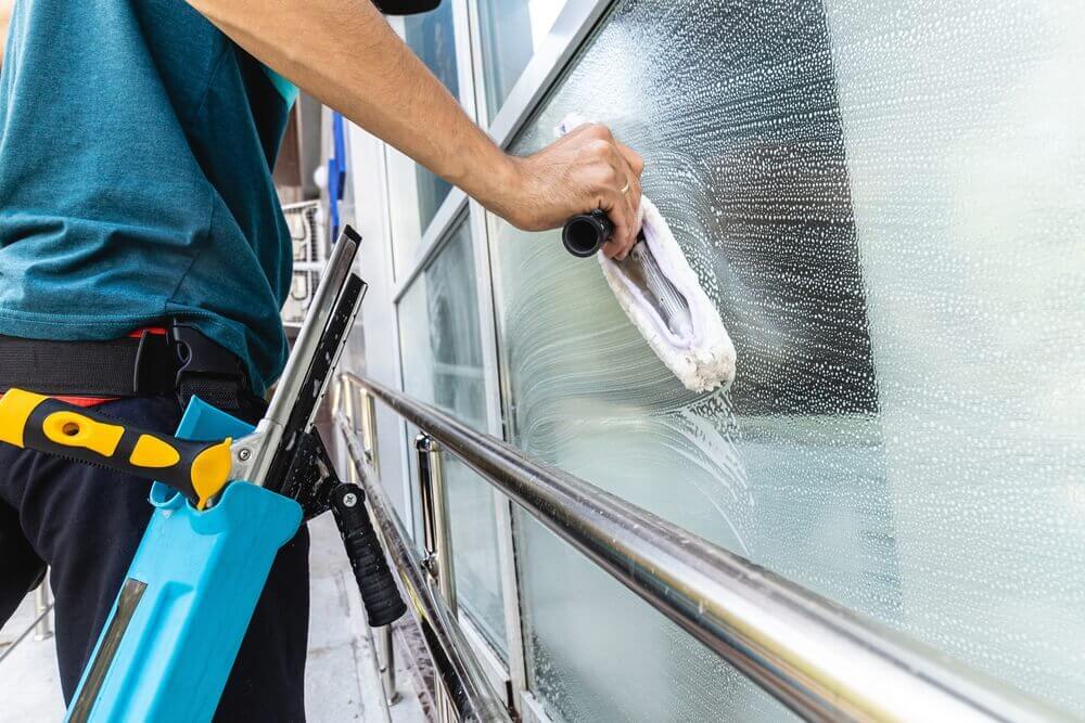 Photo of a professional performing an add-on cleaning service to a commercial building.
